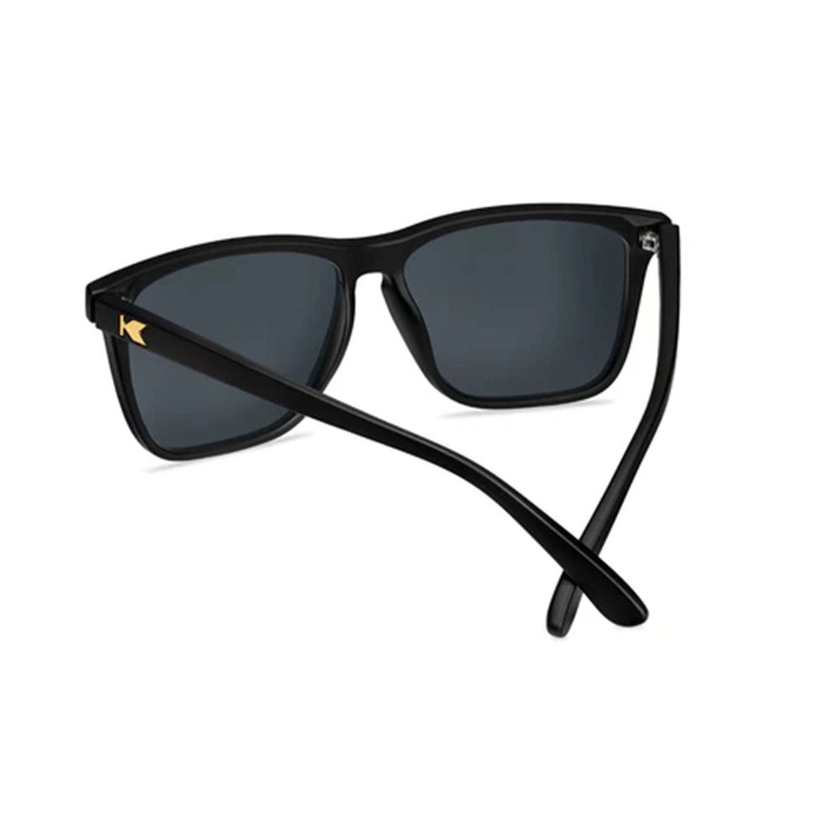 Black sunglasses with dark lenses on a white background