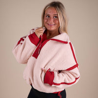 Woman posing in a FP Movement pullover.