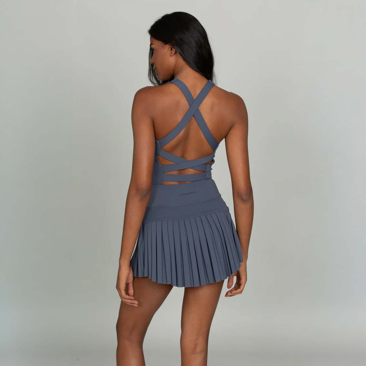 Back view of Gold Hinge navy strappy tennis dress with crisscross strappy open back.