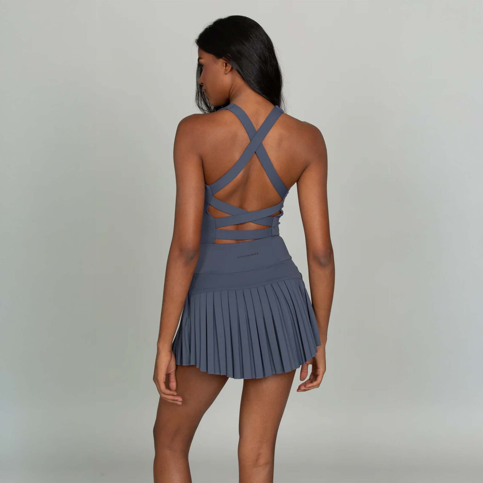 Back view of Gold Hinge navy strappy tennis dress with crisscross strappy open back.