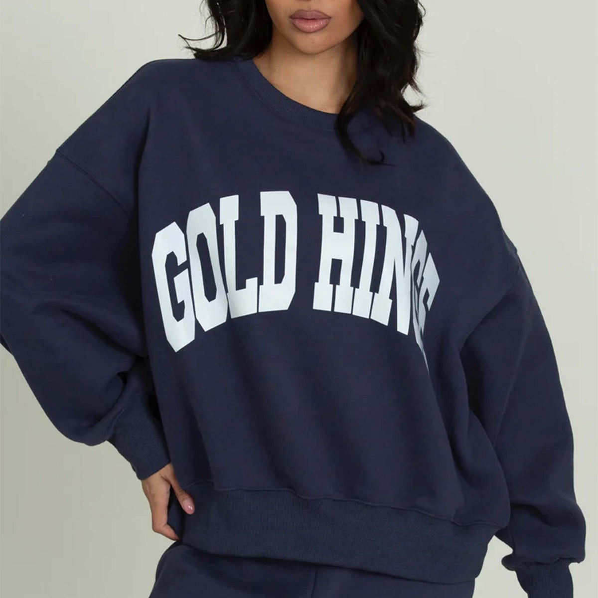 Closeup Front view of a Dark Navy Blue Gold Hinge crew neck sweatshirt with large arch gold hinge logo across the chest.