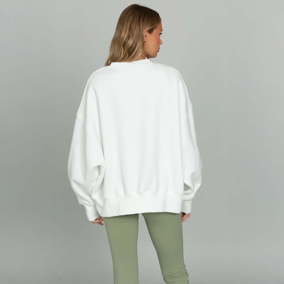 Back view White Gold Hinge Arch Crewneck with light green logo across the chest.