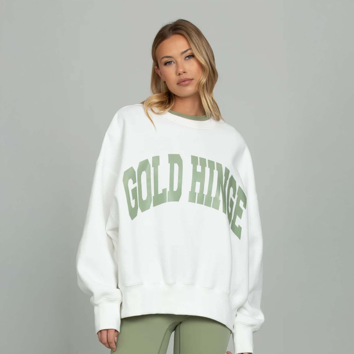 Front view White Gold Hinge Arch Crewneck with light green logo across the chest.