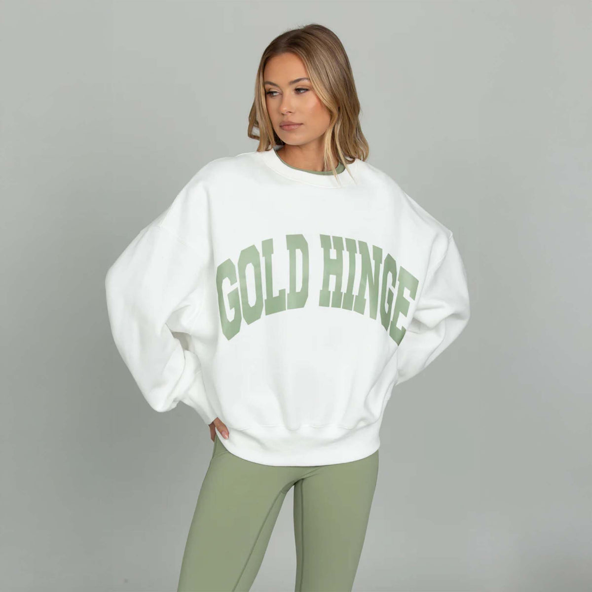 Front view White Gold Hinge Arch Crewneck with light green logo across the chest.