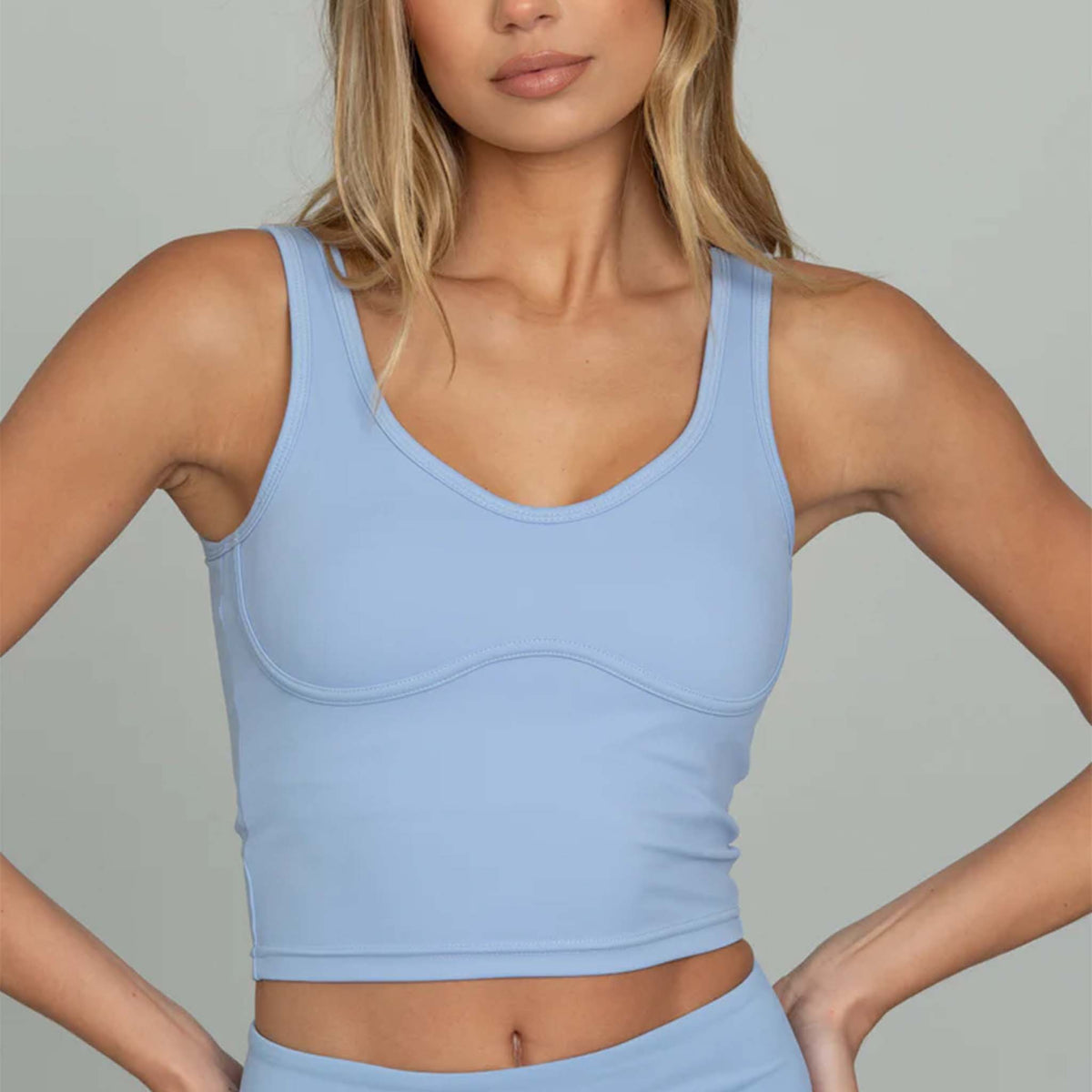 Woman wearing Gold Hinge cropped tank in French blue, front view close-up.