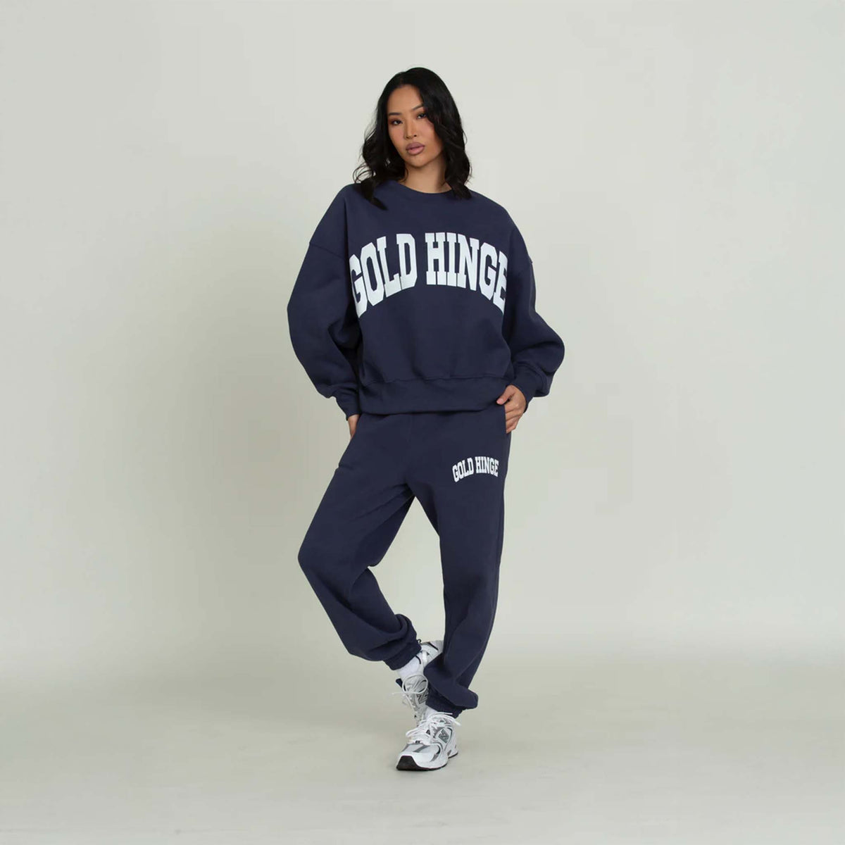 Full view of Gold Hinge jogger sweatpants in denim blue with logo detail and elastic cuffs with coordinating sweatshirt.