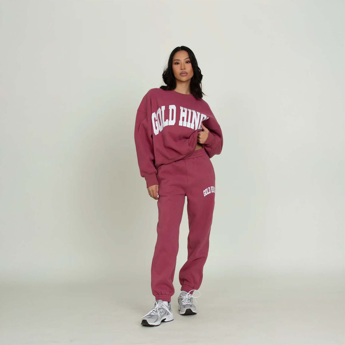 Full outfit with model in Gold Hinge jogger sweatpants and matching crewneck in pale mulberry.
