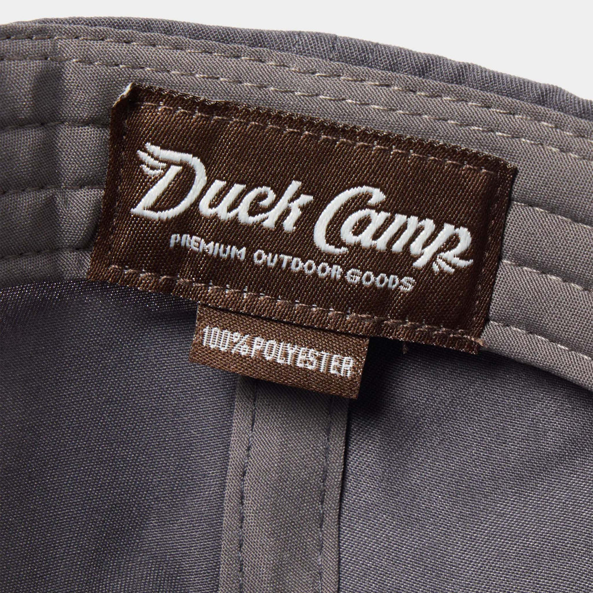 Duck Camp label on the inside of a charcoal grey hat.