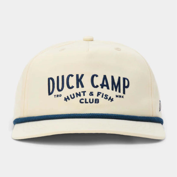 Front view of ivory Duck Camp hat with navy embroidered “Duck Camp Hunt & Fish Club” text and blue rope detail across the bill.