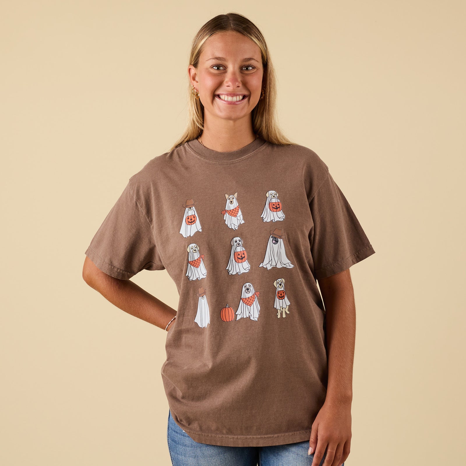 Front view of brown t-shirt featuring Halloween ghost puppies graphic with jack-o’-lantern buckets and festive details.