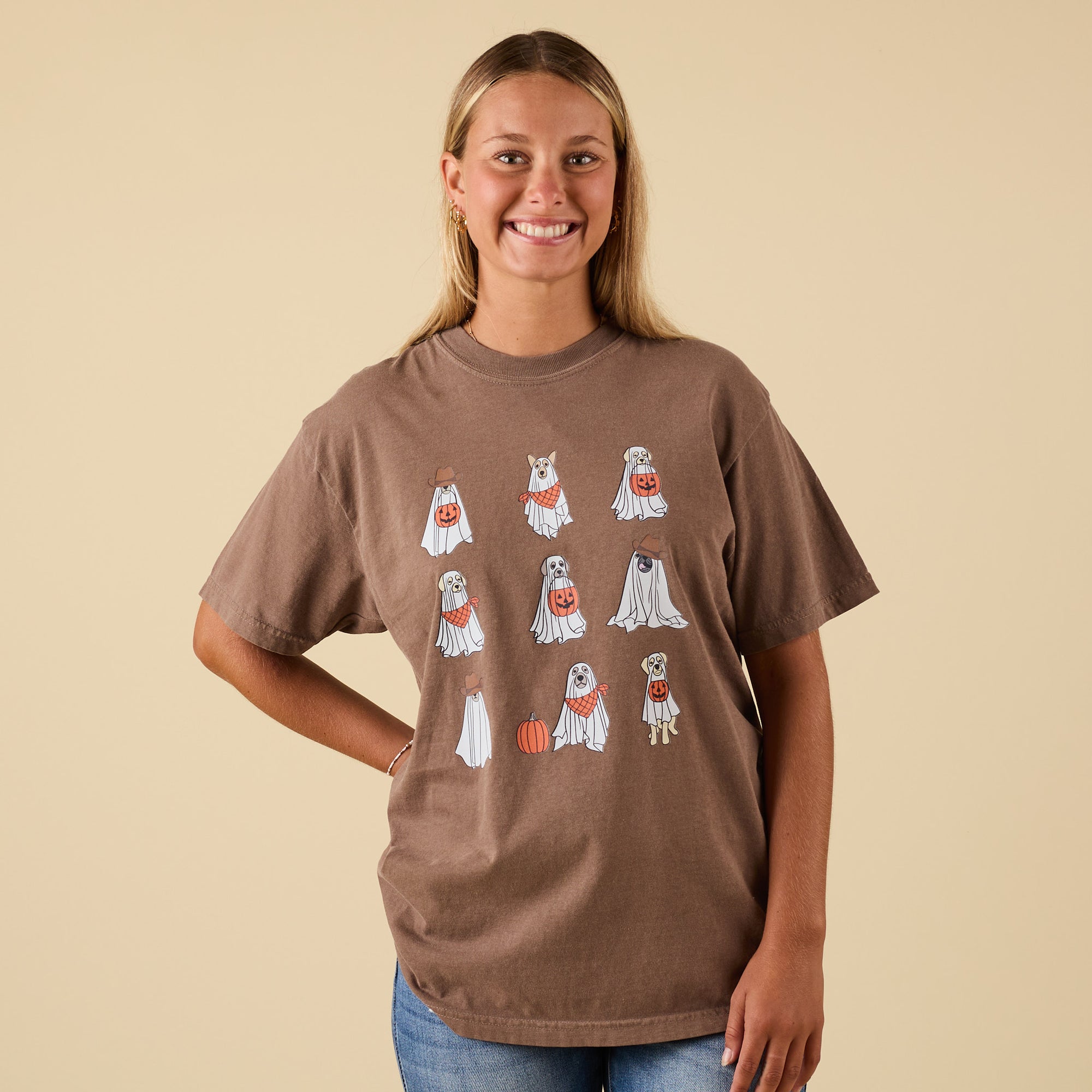 Front view of brown t-shirt featuring Halloween ghost puppies graphic with jack-o’-lantern buckets and festive details.