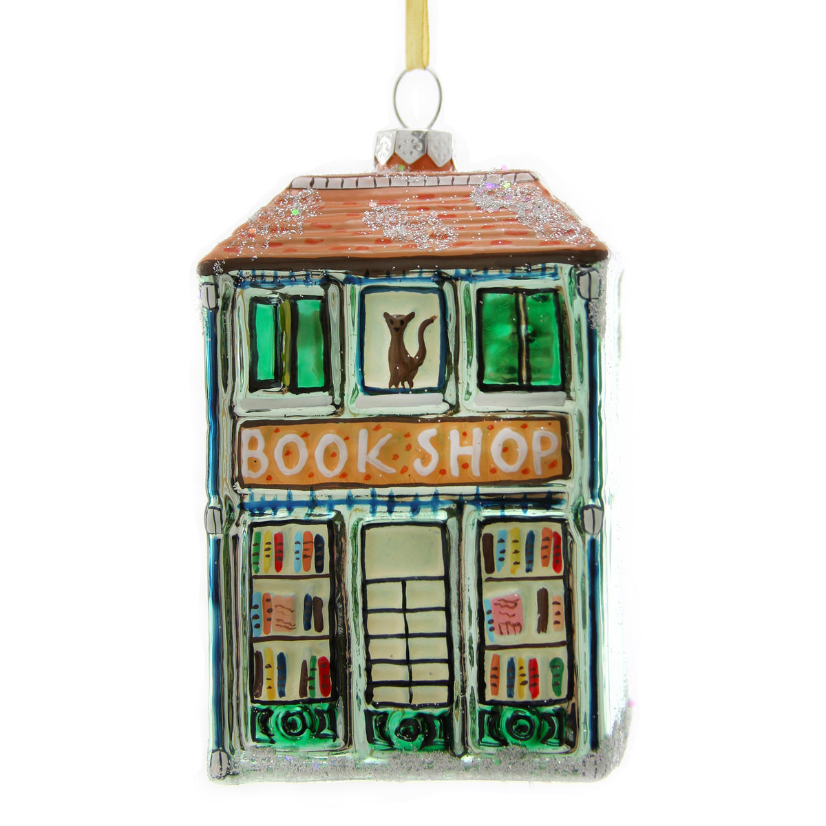 Colorful glass ornament shaped like a bookstore with glitter roof and a cat in the window.