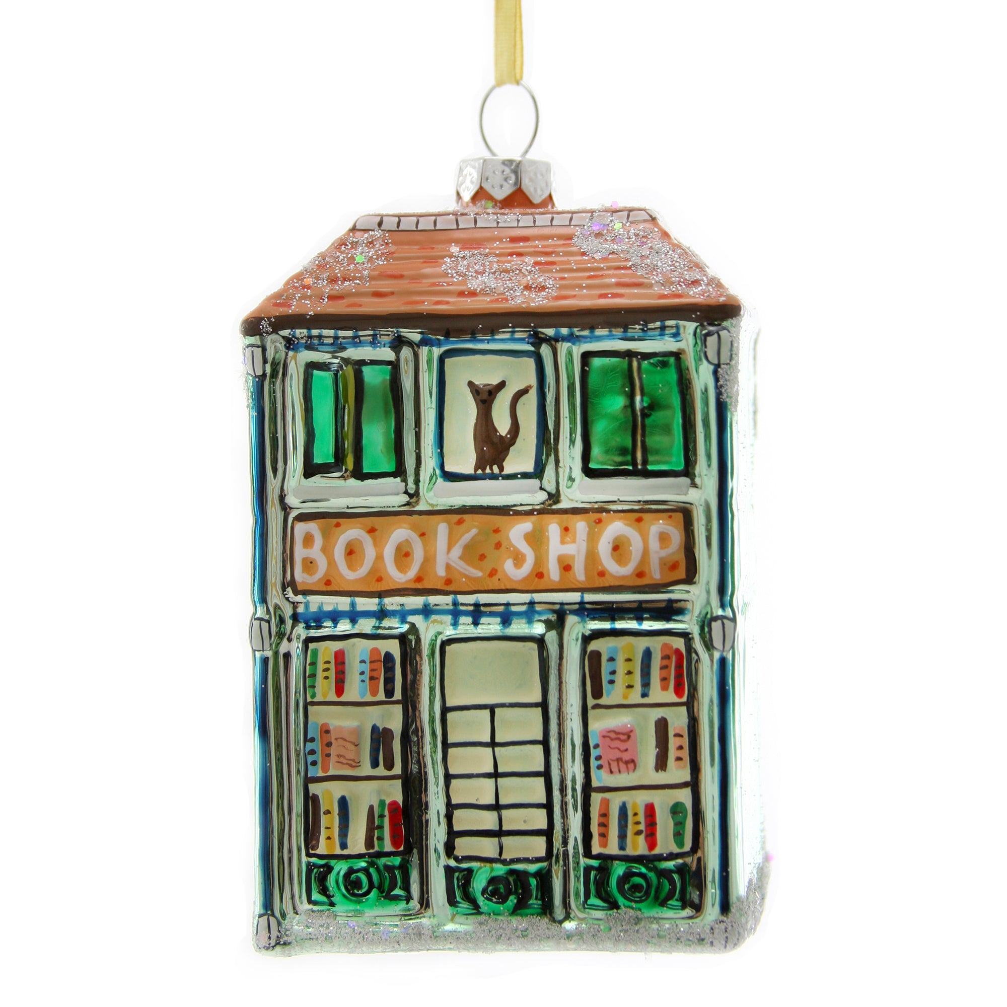 Colorful glass ornament shaped like a bookstore with glitter roof and a cat in the window.