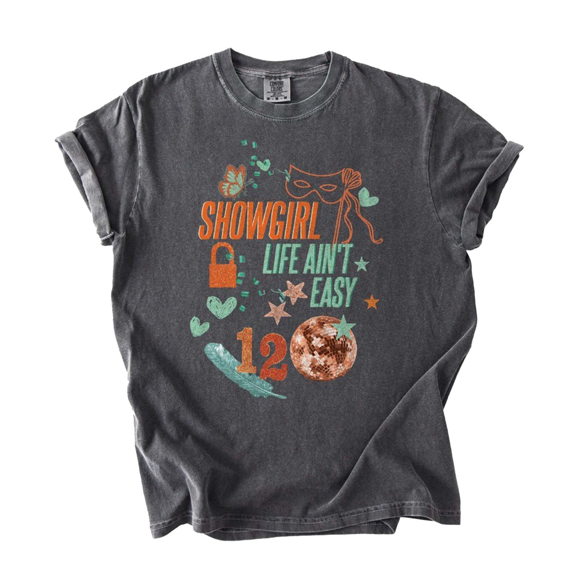 Front view of pepper-wash short sleeve t-shirt with “Showgirl Life Ain’t Easy” text, masquerade mask, disco ball, hearts, and star graphics.