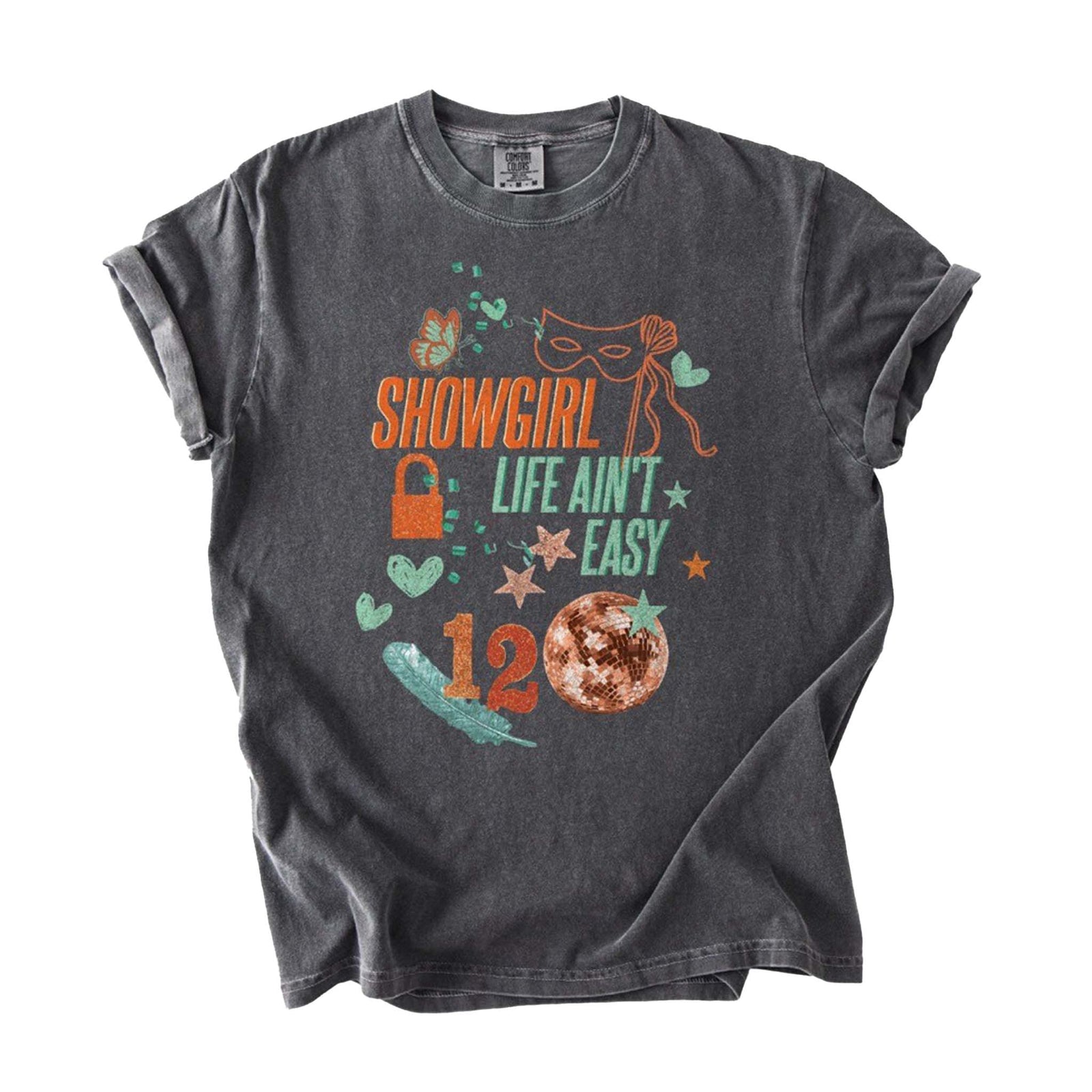 Front view of pepper-wash short sleeve t-shirt with “Showgirl Life Ain’t Easy” text, masquerade mask, disco ball, hearts, and star graphics.