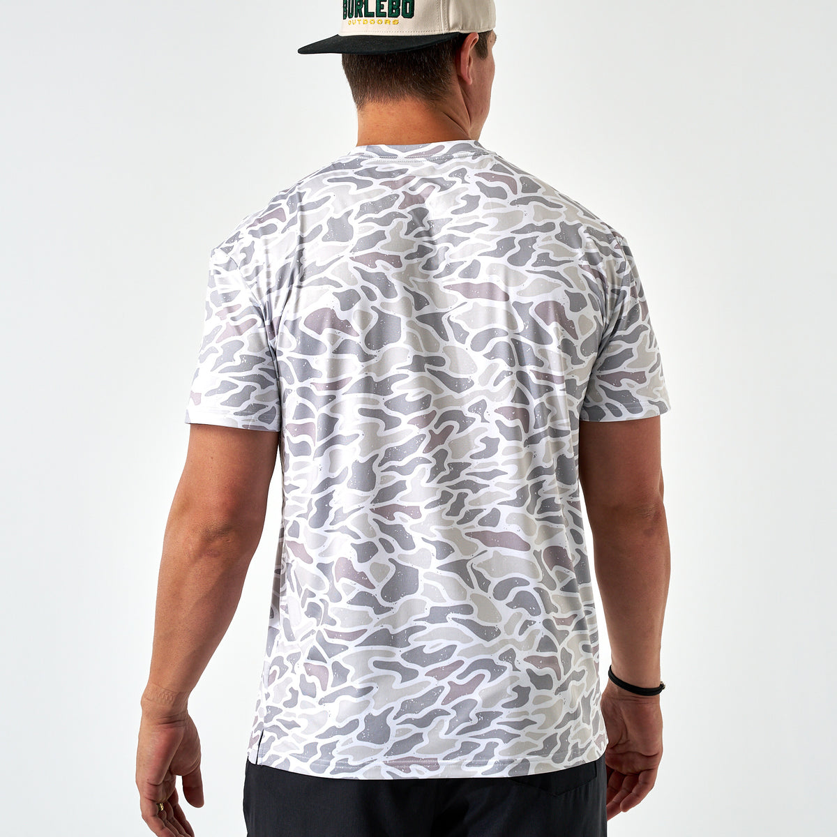 Person wearing a white camouflage t-shirt on a white background