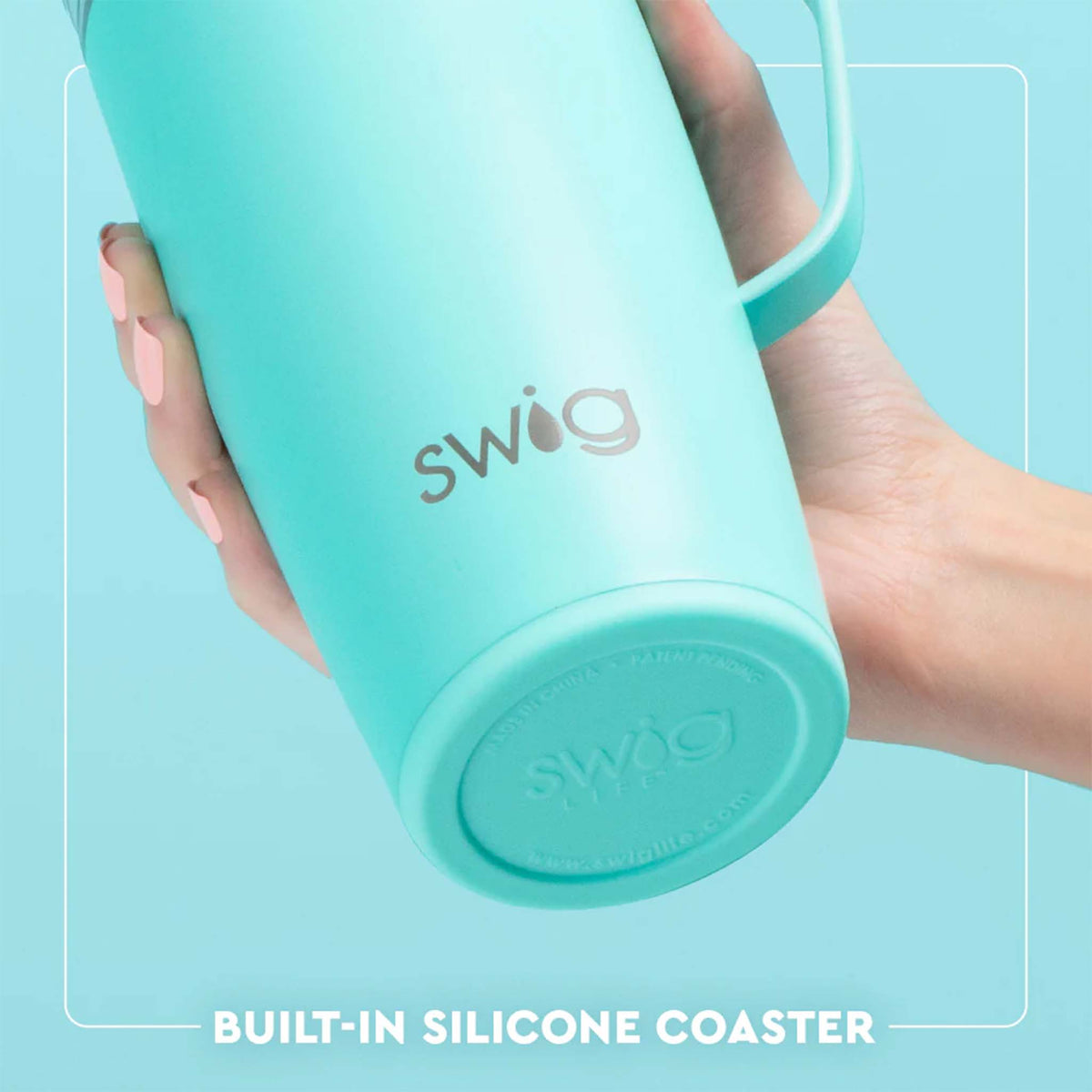 Close-up of light teal Swig Life 22oz travel mug showing built-in silicone coaster base, held in hand.