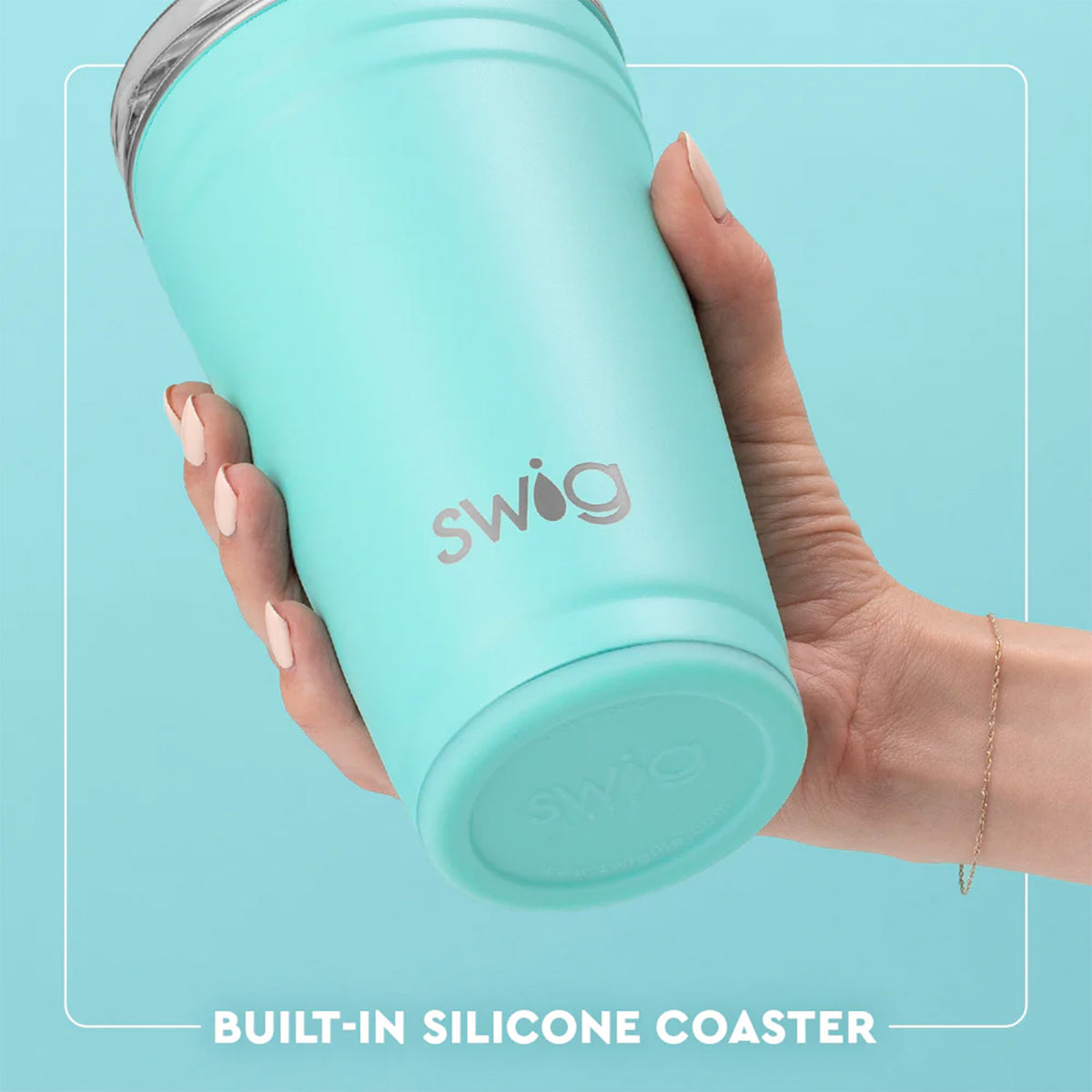 Close-up of light teal Swig Life party cup showing built-in silicone coaster base, held in hand.