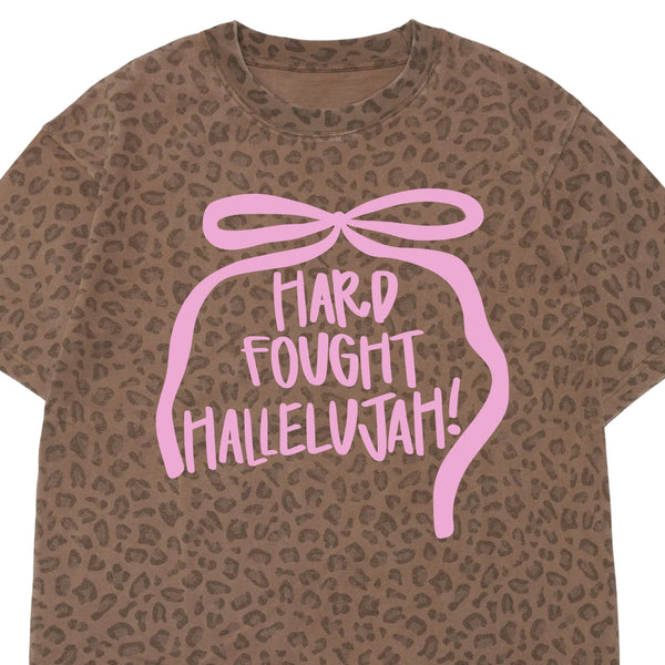 Cheetah Print Short Sleeve T-Shirt with light pink bow graphic and Hard-Fought Hallelujah! text shown on a white background.