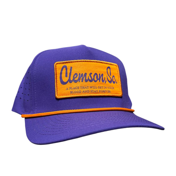 Purple cap with orange patch featuring 'Clemson, Sc.' text on a white background