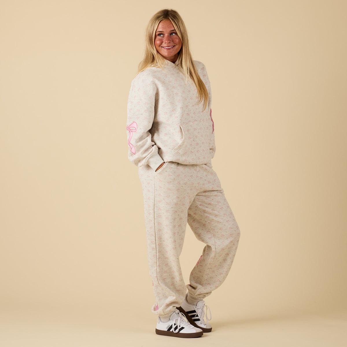 Full outfit with model wearing Alice Pink Bow Sweatpants and matching hoodie.