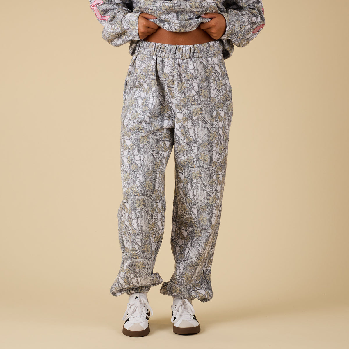 Front view of camo sweatpants with elastic waistband and relaxed fit.