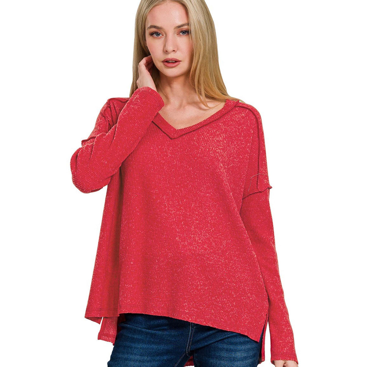 Woman wearing a red sweater against a white background