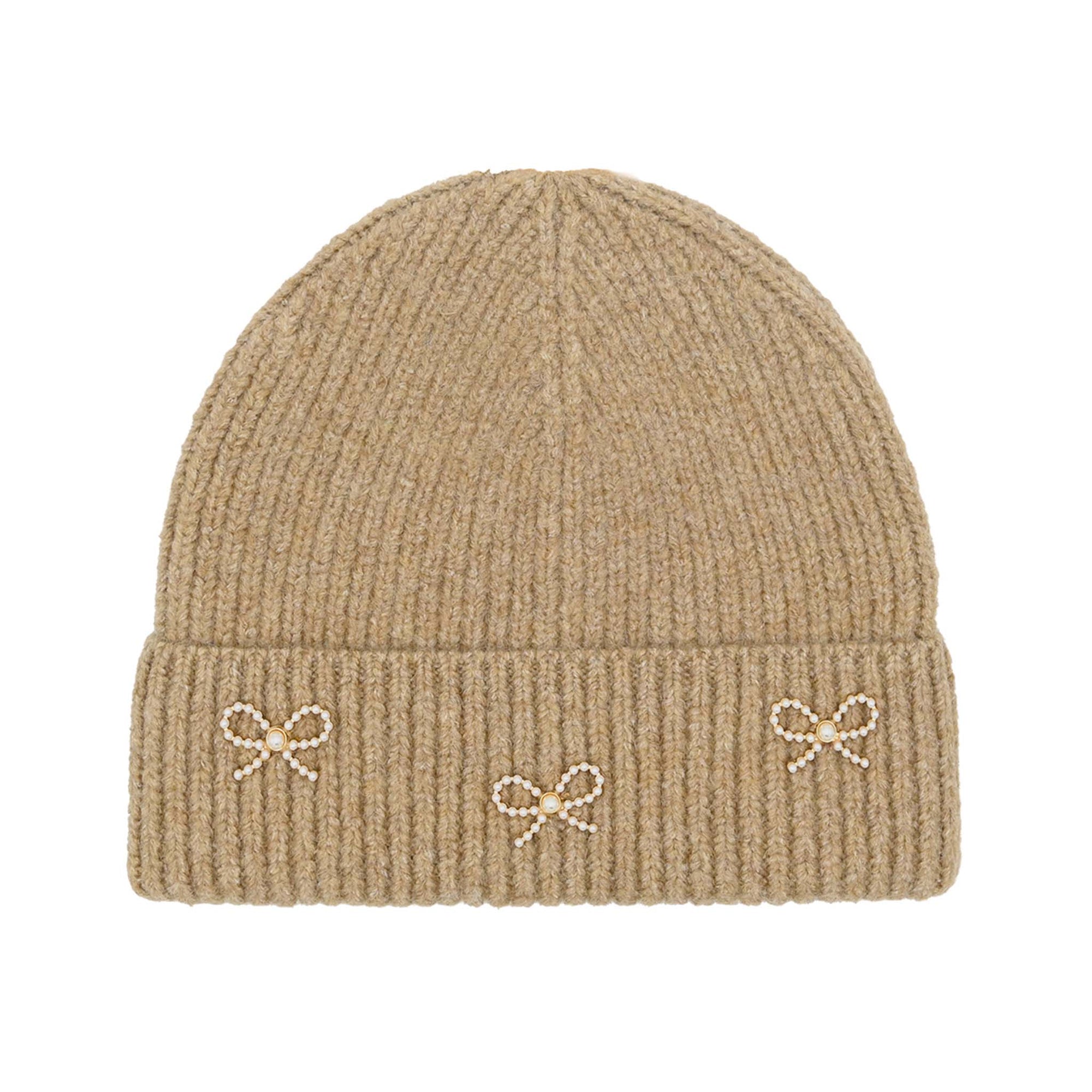 C.C ribbed knit beanie in taupe with three small pearl and bead bow embellishments across the fold-over cuff, laid flat on a white background.