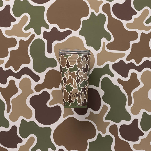 Swig Life 22oz travel mug in Hunting Camo pattern placed against matching green, brown, and tan camo background.