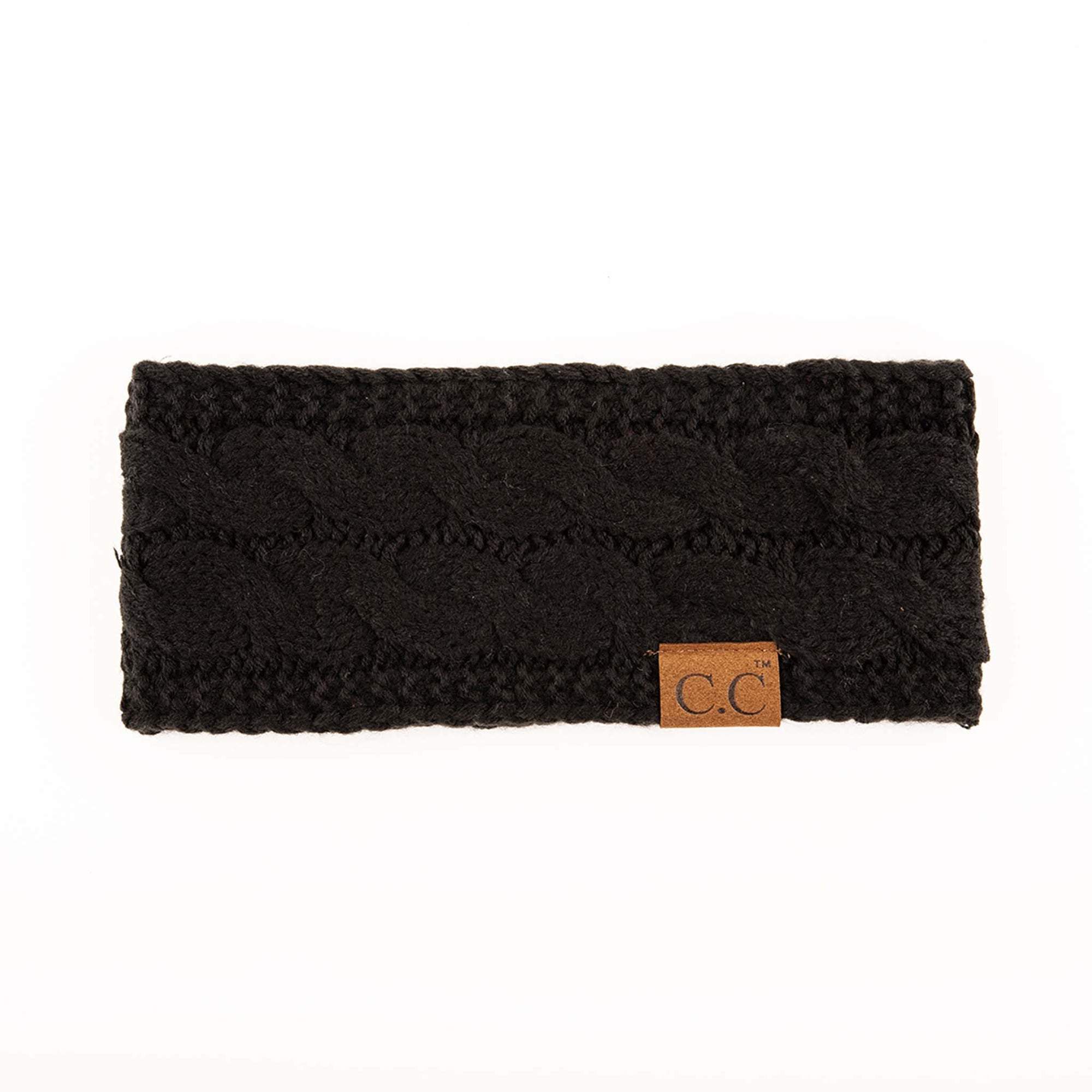 Black cable knit C.C headband with brown leather logo patch, laid flat on a white background.
