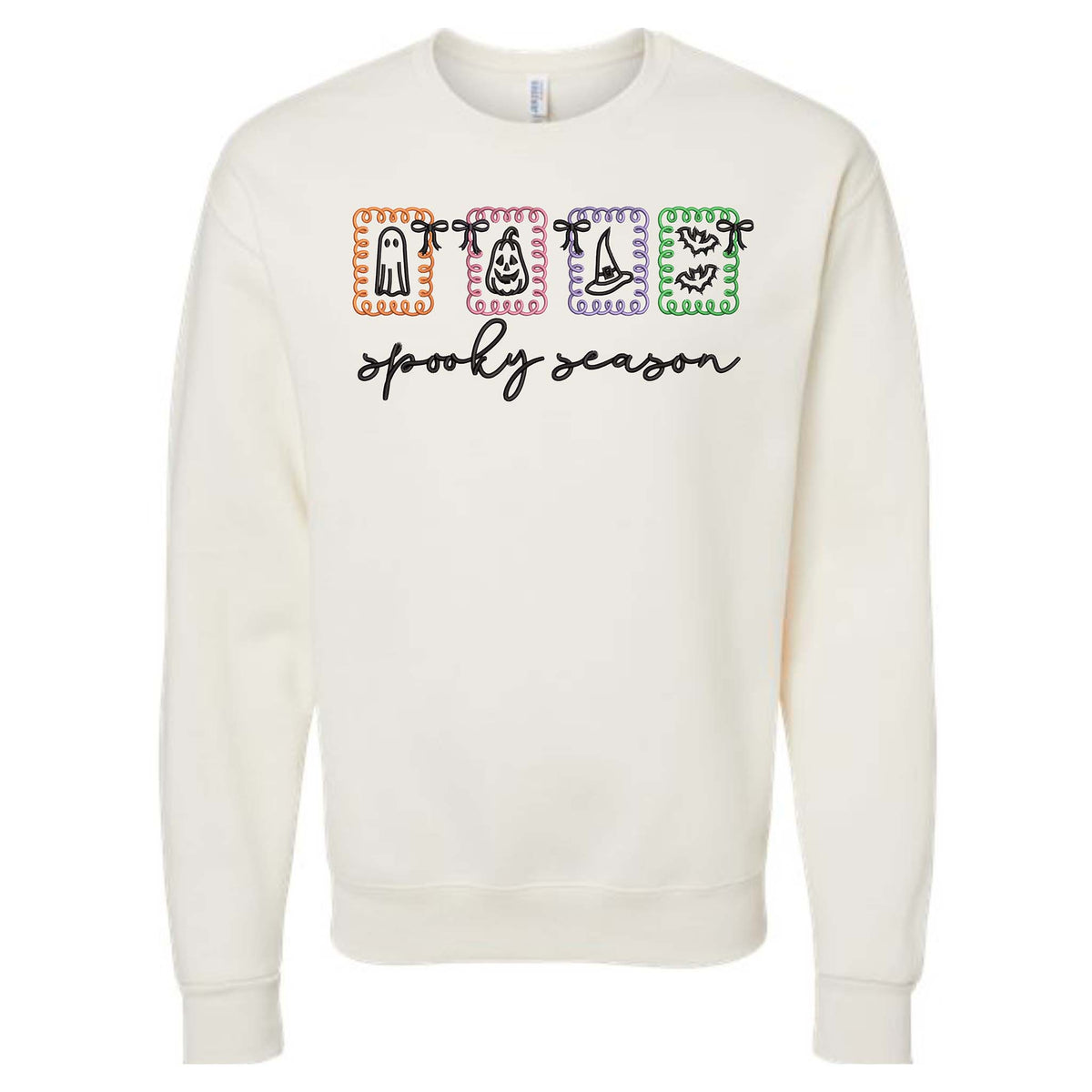 Ivory crewneck sweatshirt with colorful Halloween graphic blocks featuring ghost, candy corn, witch hat, and bats with “spooky season” text.