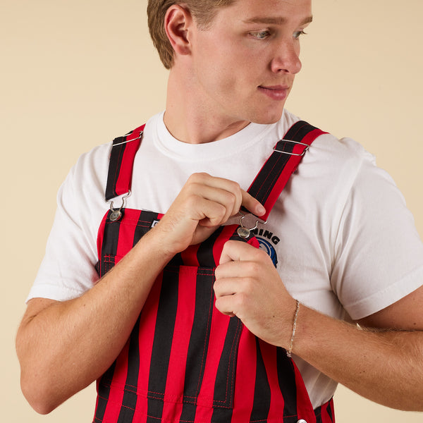 Close up view of a man in red and black striped overalls.