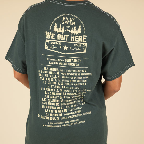 Back of Riley Green tour t-shirt showing "We Out Here" 2021/22 tour dates and cities in bold text and cream graphics.