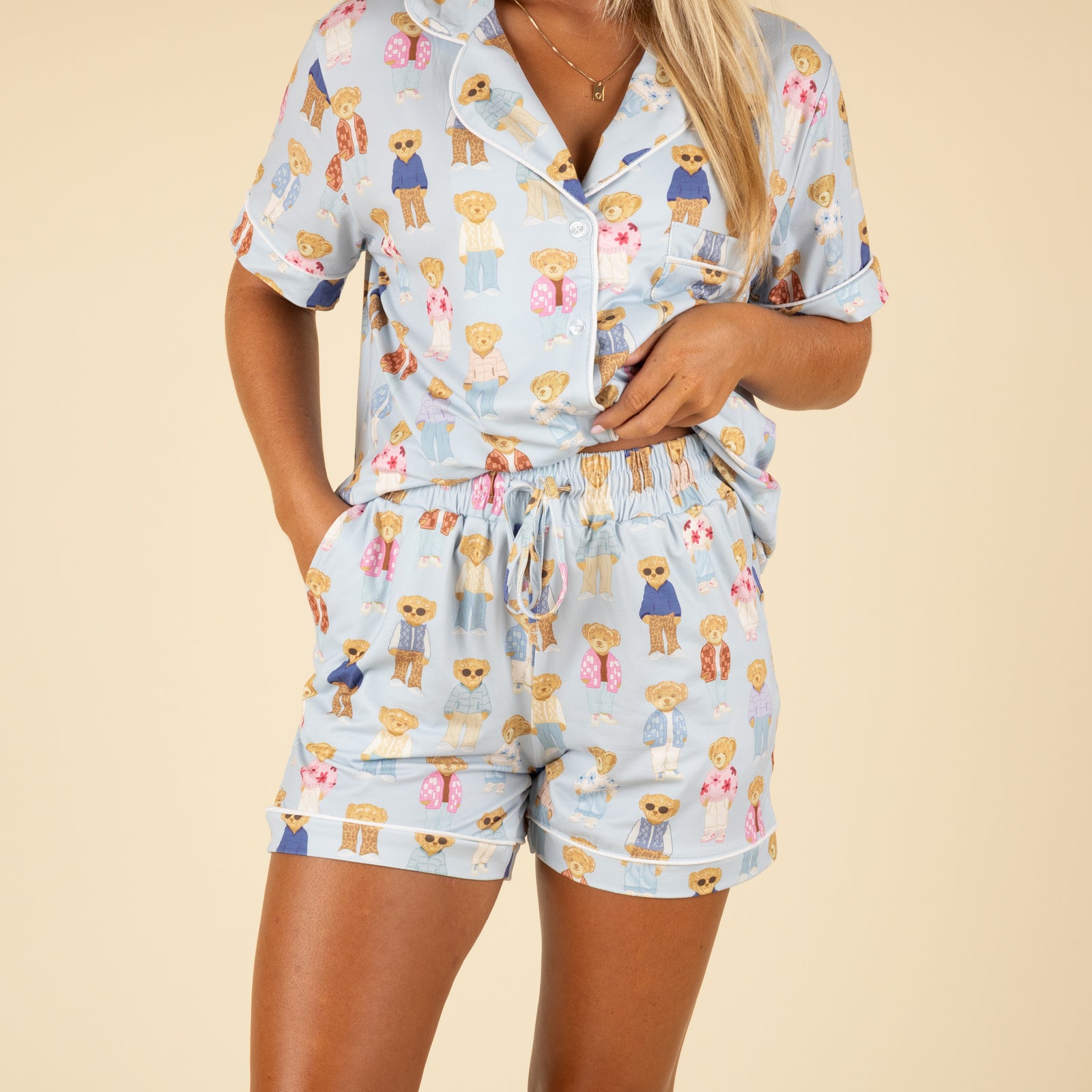 Front view of woman wearing pajama shorts with elastic waistband and teddy bear print