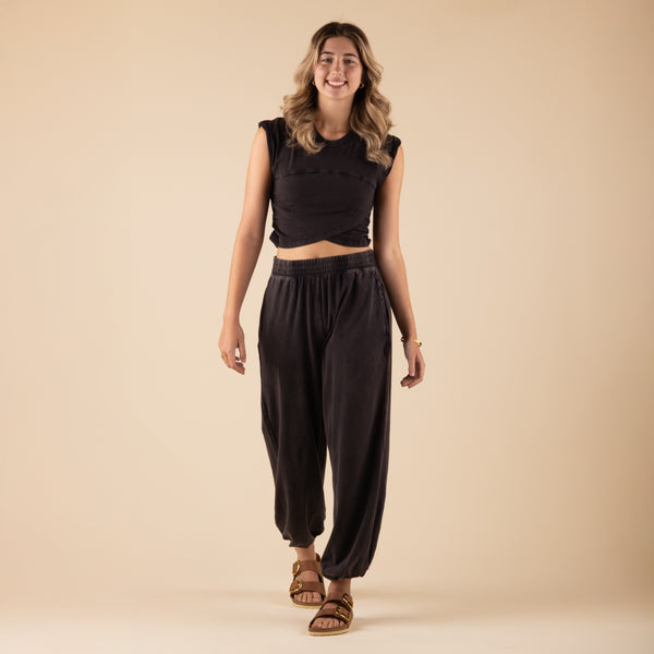  Woman Wearing Free People Movement Hot Shot Crossover Set, color black, sizes XS-L, machine washable, 95% cotton, 5% elastane
Soft, jersey fabrication; relaxed fit; cropped muscle tee top with seaming detail; ankle length pant with high-rise waist and wide leg; elasticated waistband and cuffs; crossover detail on top; ribbed collar; side seam pockets