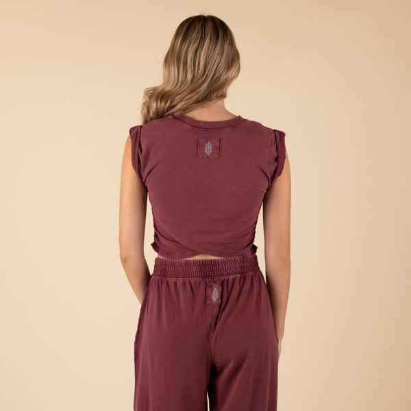 Woman Wearing Free People Movement Hot Shot Crossover Set, color clove, sizes XS-L, machine washable, 95% cotton, 5% elastane
Soft, jersey fabrication; relaxed fit; cropped muscle tee top with seaming detail; ankle length pant with high-rise waist and wide leg; elasticated waistband and cuffs; crossover detail on top; ribbed collar; side seam pockets