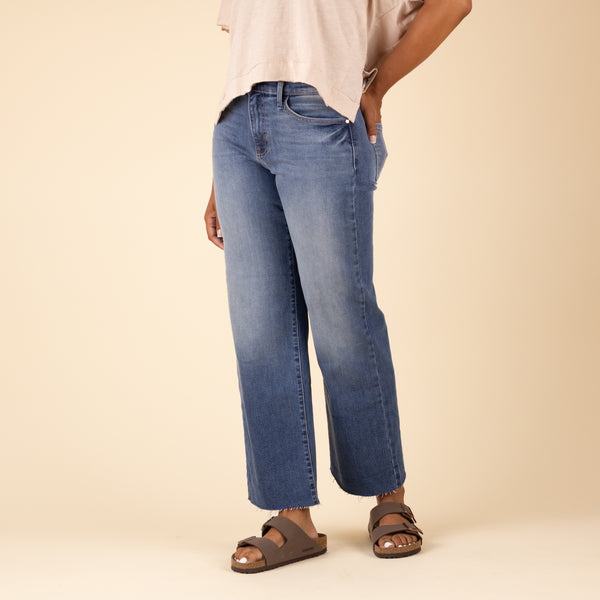 Alternate side view of Just Black Denim Palazzo Jeans in medium wash, featuring wide-leg silhouette, fading at the knee, and frayed hem.