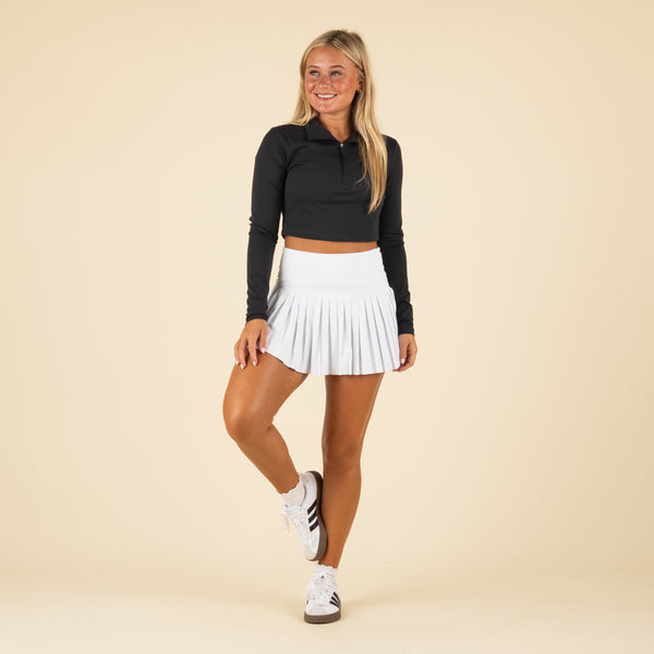 Full body Front view of a white pleated gold hinge skort.