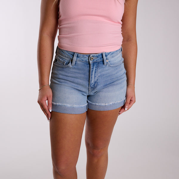 Light wash high-rise denim shorts with cuffed frayed hem shown from front angle.