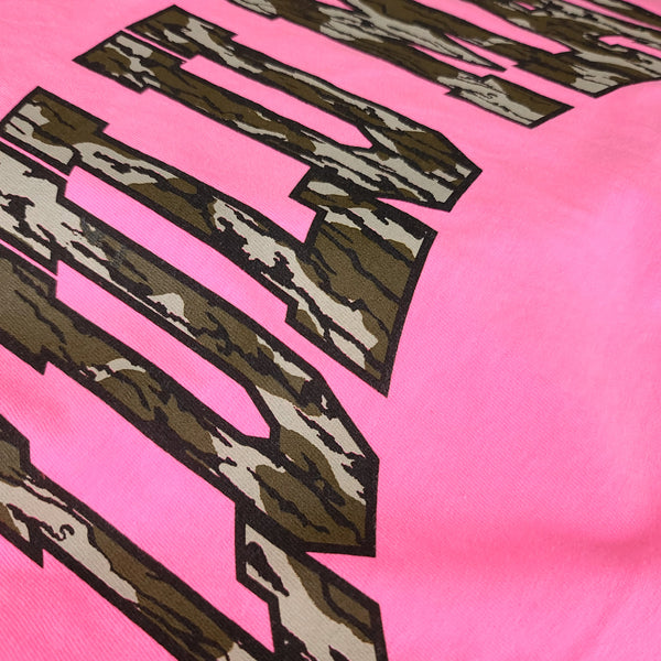 Close-up detail of camo “LULU MAC” graphic printed on neon pink Lulu Mac short sleeve t-shirt fabric.