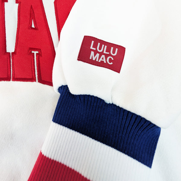 Color-blocked sweater with 'LULU MAC' label on a white background