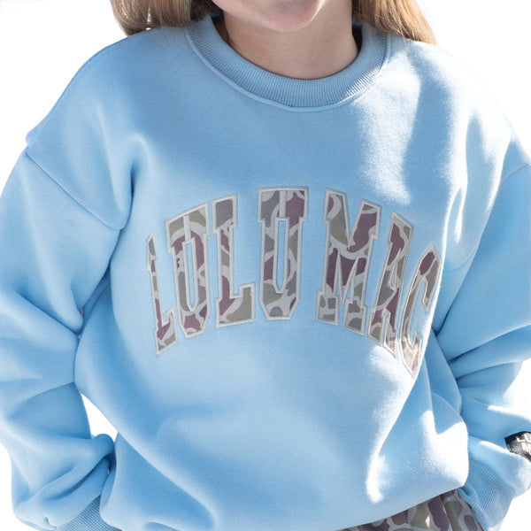 Light blue Youth sweatshirt with 'LULU MAC' camo print across the front chest shown on a white background