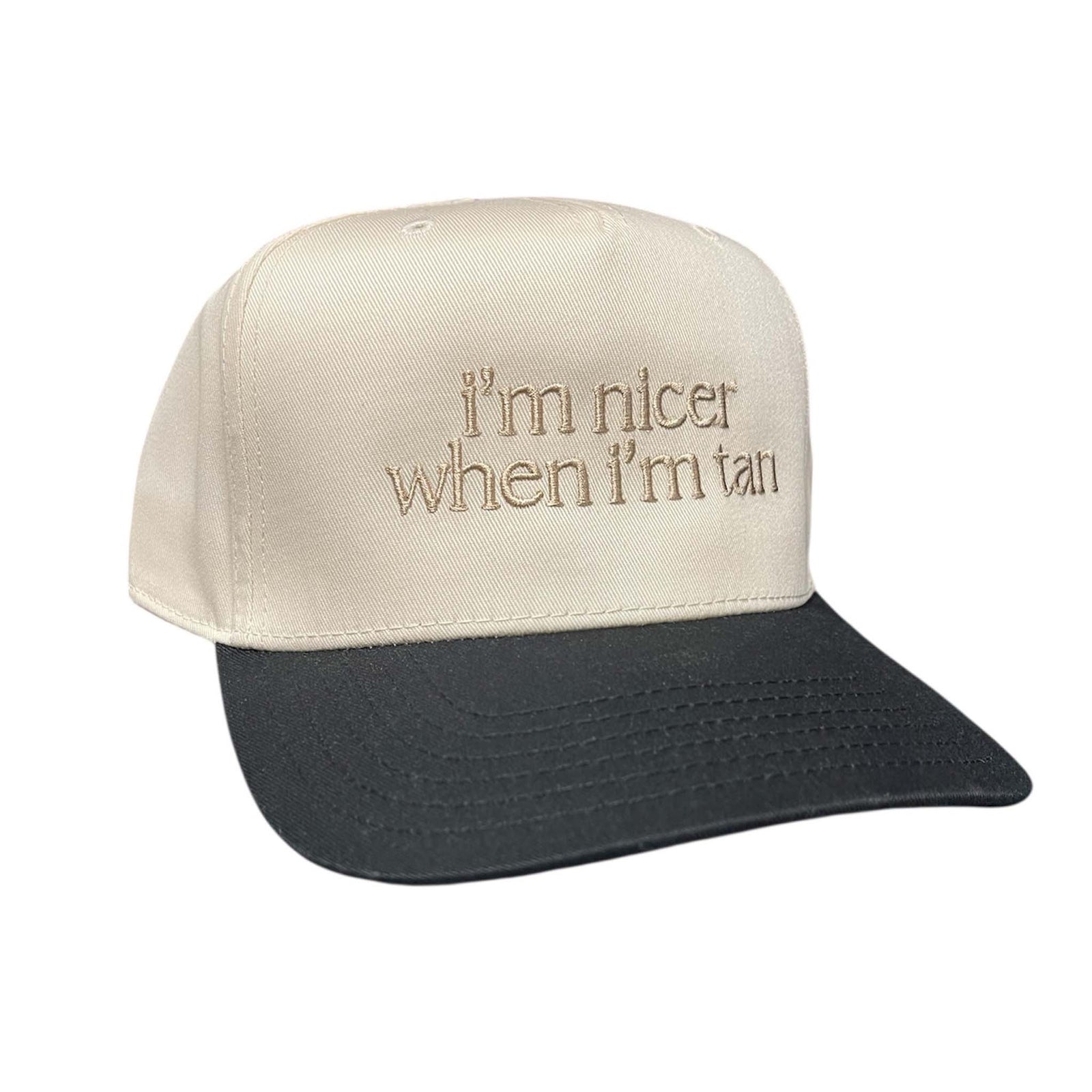 Katydid I'm Nicer When I'm Tan hat, color light tan and black, adjustable sizing.
Light Tan front and a contrasting black brim, tan embroidery that reads "I'm nicer when I'm tan".  Structured fit. 