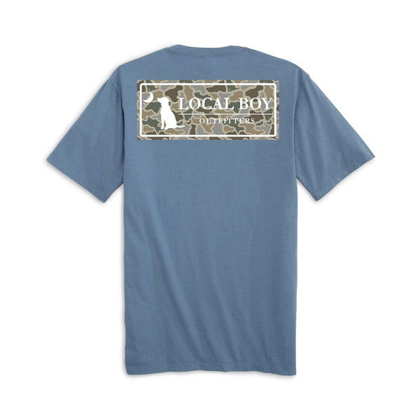 Local Boy Outfitters short sleeve t-shirt in slate blue. Back features a rectangular camo graphic with a white dog silhouette and crescent moon beside the brand name.