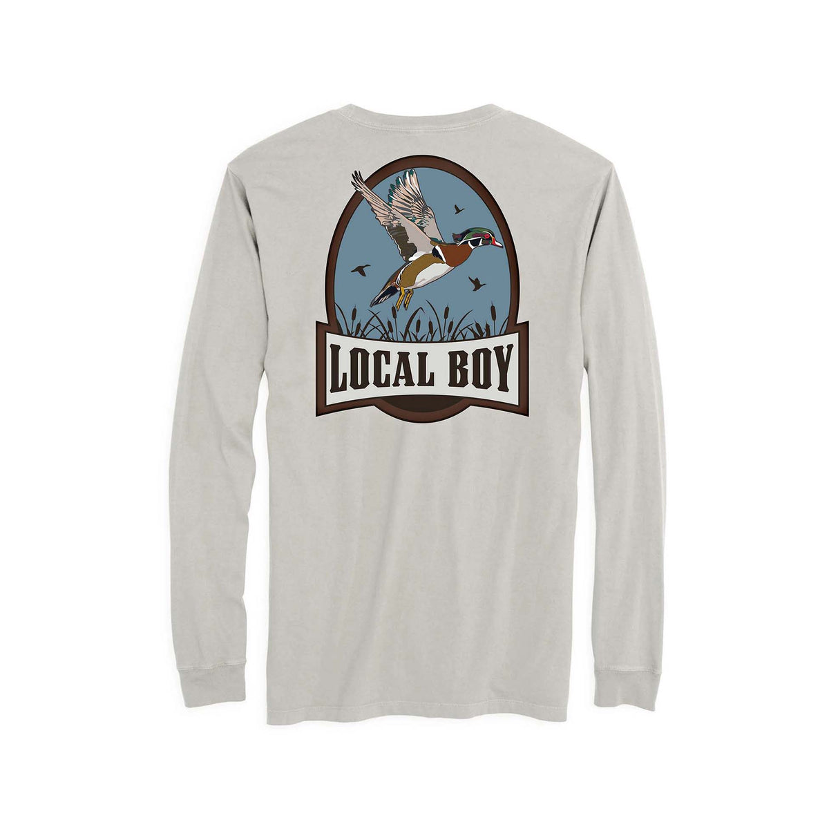 Youth silver long-sleeve tee featuring a large back graphic of a flying mallard over marsh grass with “LOCAL BOY” text in a brown oval frame.