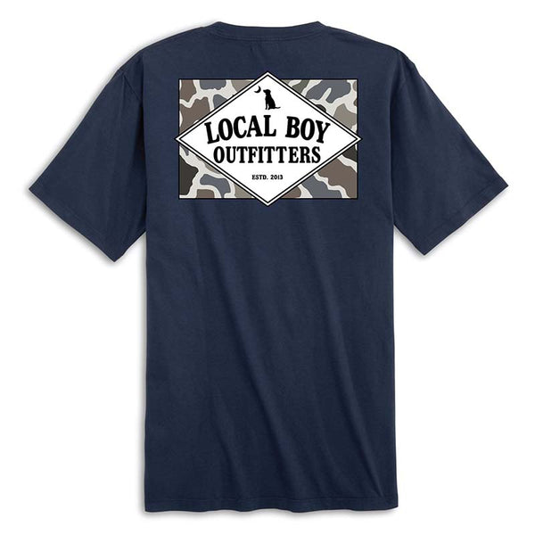 Local Boy Outfitters short sleeve t-shirt in navy. Back features a camo background with a white diamond graphic that reads “Local Boy Outfitters Estd. 2013” with a dog and crescent moon.