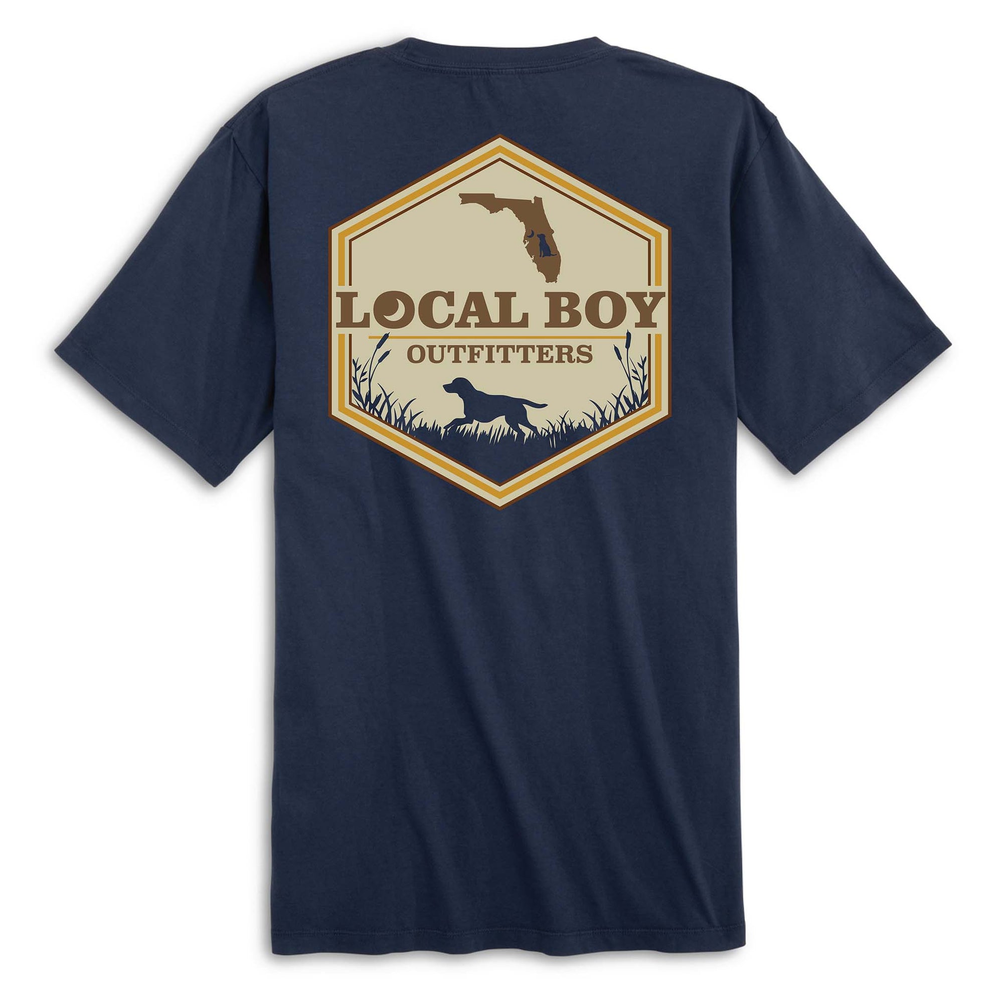 Back view of navy short sleeve t-shirt with large hexagon-shaped graphic featuring a brown silhouette of Florida, “Local Boy Outfitters” text, and a black silhouette of a dog standing in grass with cattails.