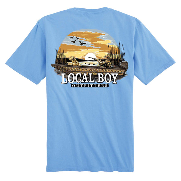 Back view of washed denim short sleeve t-shirt with Local Boy Outfitters logo, hunter and dog in boat at sunset with flying ducks.
