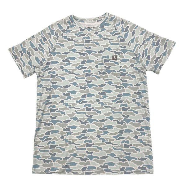 Local Boy Outfitters Heather Blend Short Sleeve T-shirt, color Cool Oak Camo, sizes S-XXXL. Cool Oak Camo is a pattern featuring shades of blue, gray, and tan. Lightweight heather-blend performance crew shirt made from 64% viscose from bamboo, 28% polyester, and 8% spandex. Features moisture-wicking, sun-resistant, and quick-drying properties with added stretch for comfort. Includes a front pocket with an LBO logo clamp, designed for both men and women for versatile outdoor use.