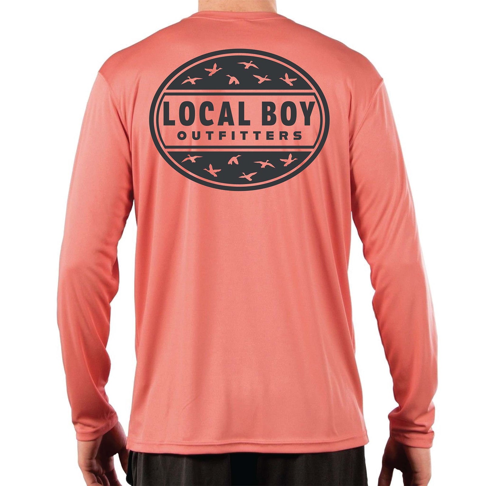 Local Boy Outfitters long sleeve performance shirt in salmon. Back features a large black circular logo with flying duck silhouettes and “Local Boy Outfitters” text across the center.